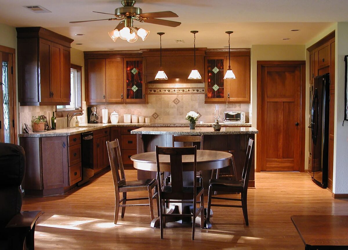 Cherry cabinetry kitchen with round dining table