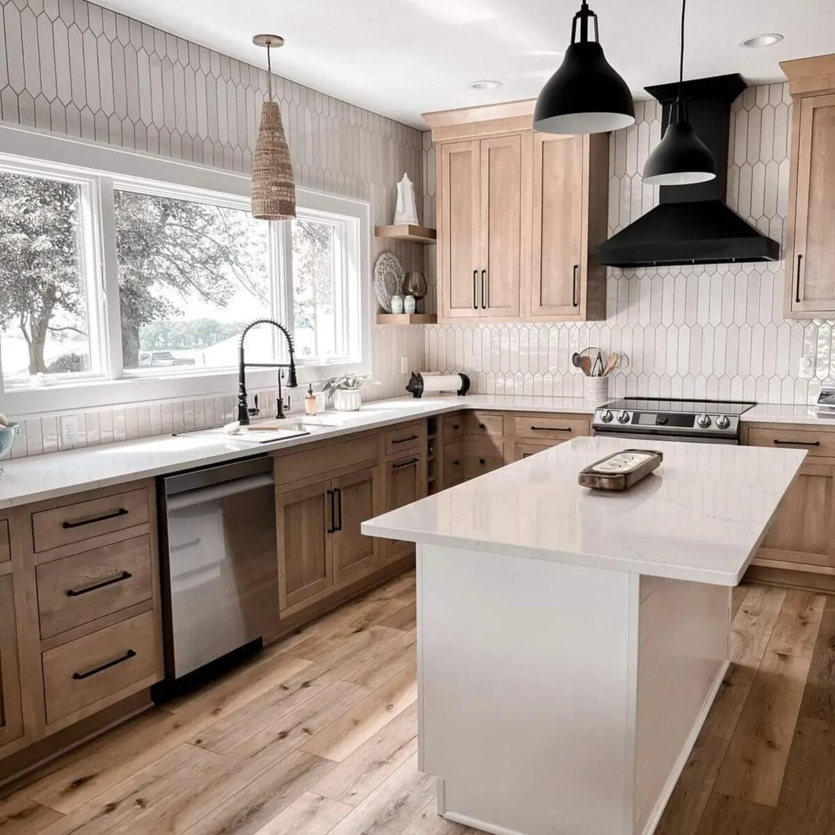Modern natural wood kitchen with black range hood