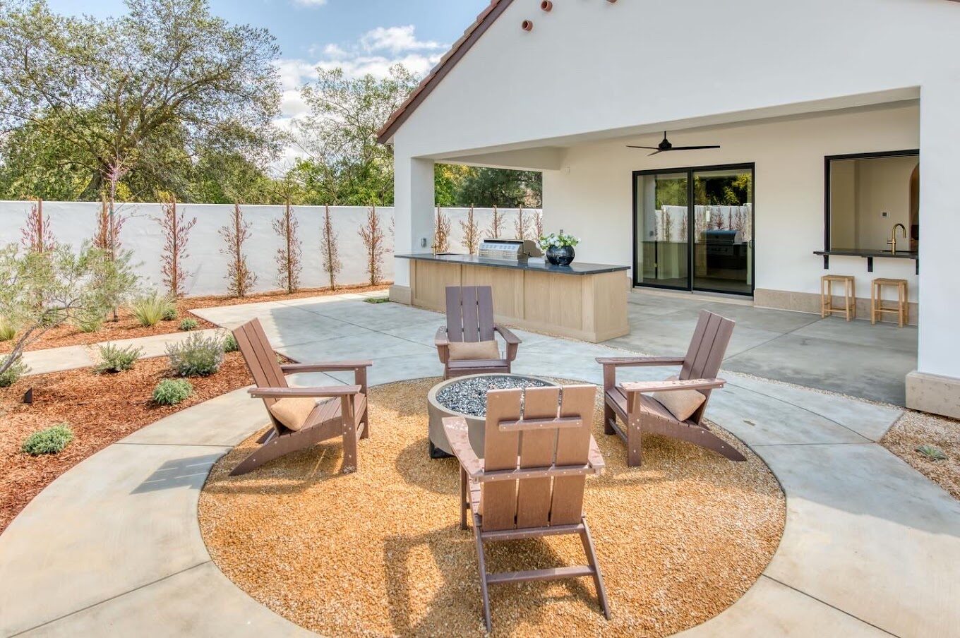 Backyard patio with fire pit and outdoor kitchen