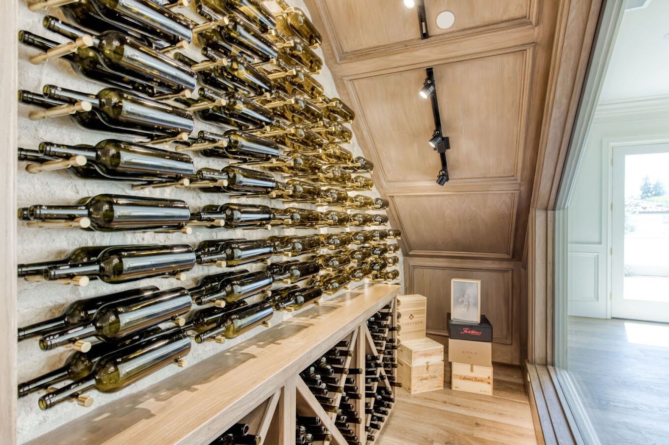 Custom wine wall with angled bottle display and oak racking